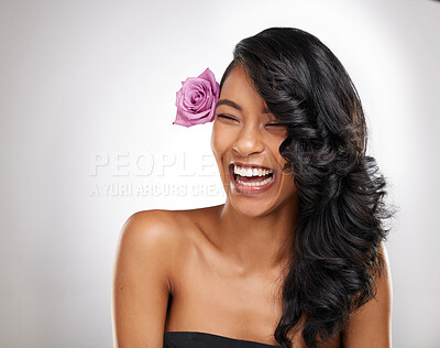Buy stock photo Shot of a beautiful young woman posing with a flower in her hair