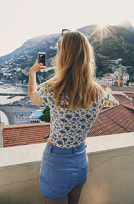 Buy stock photo Woman taking photos of Italy coast using smartphone. Rear view of woman taking pictures of ocean view on vacation