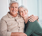 Happy senior caucasian couple bonding at home. Smiling and affectionate mature husband and wife hugging while relaxing together. Cheerful man and woman in a loving relationship enjoying retirement