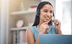 One young hispanic happy and cheerful female call center agent wearing a headset and working in customer service at work. Face of a hispanic woman answering calls working at a call centre on a laptop 