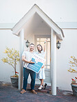 Couple buying a house together. Couple holding keys in front of their house. Happy couple moving in together. caucasian couple pose outside their new house. Smiling couple outside holding keys