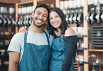 Portrait of a happy young hispanic man and woman working in a store or cafe. Friendly couple and coffeeshop owners managing a successful restaurant startup