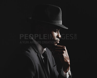 Buy stock photo African american man posing against a black background wearing a suit and hat looking mindful and sad.Grieving person suffering depression and anxiety while mourning a loss.Vintage hitman in the mafia