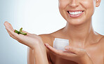 Closeup of smiling unknown woman using aloe vera in her skincare routine. Caucasian model isolated against grey studio background and posing with copyspace. Organic plants for hydration and moisture