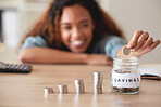 Unknown mixed race woman calculating and stacking a variety of coins and depositing them into a savings jar. Hispanic woman collecting coins as finance plan to budget for the future, earning interest