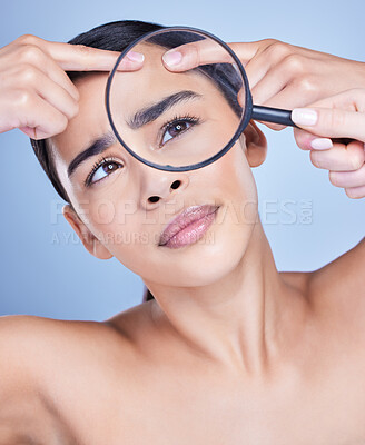 Buy stock photo A beautiful mixed race woman posing with a magnifying glass. Young hispanic obsessed with targeting acne against a grey copyspace background