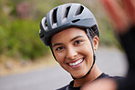 Portrait of a happy mixed race athletic young woman taking a selfie during a break from cycling outside . Sporty fit mixed race female wearing a helmet and taking a break to take photo of herself. Smiling is good for your health