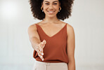 Young mixed race hispanic businesswoman extending her hand out for a handshake at work. Happy businesswoman giving a handshake while smiling at work