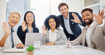 Portrait of diverse corporate businesspeople waving hello to colleagues during a virtual teleconference meeting via video call in an office boardroom. Happy staff greeting during online global webinar