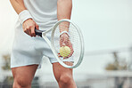 Closeup of unknown mixed race tennis player getting ready to serve on court. Hispanic fit athlete holding racket and a ball during match. Active and healthy man playing a game as exercise and training
