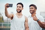 Portrait of two smiling ethnic tennis players taking selfie on cellphone after playing court game. Happy ethnic athletes team bonding, taking picture on phone. Friends play sports for healthy fitness