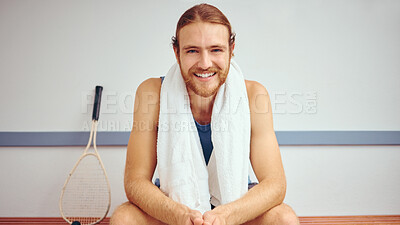 Buy stock photo Portrait of a squash player with his racket. Caucasian man sitting in a gym locker room relaxing. Fit, young athlete taking a break before his match. Happy healthy player sitting in his gym