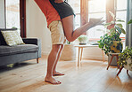 Close up of young boyfriend in shorts lifting girlfriend up in modern apartment. Romantic young couple hugging in living room and enjoying passionate dance at home