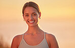 Portrait of yoga woman outside after outdoor practice in remote nature at sunset. Beautiful smiling young caucasian standing alone. One happy healthy person feeling cheerful, content, zen and mindful