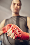 Closeup on hands of boxer with chalk on bandages. Hands of mma fighter ready for combat. Strong athlete with powder on bandage for boxing. Ready to throw a punch. Ready for boxing practice