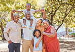 Portrait happy african american family of six spending quality time together in the park during summer. Grandparents, parents and children bonding together outside. An outing with the children