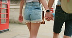 Closeup of couple walking and holding hands while on vacation