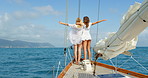 Two carefree young woman hugging and enjoying the view from the boat during a cruise in Italy. Happy friends enjoying the view of the ocean during a cruise while hugging each other