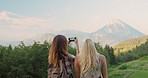 Two women taking photo. Best friends taking photos on holiday.