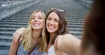 Two happy women taking selfies together. Two friends taking selfies while on holiday together
