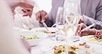 Closeup of people eating food at a table. Men and women at a restaurant having a healthy dinner party. Group of friends having a green salad served with white wine. Family and friends dining